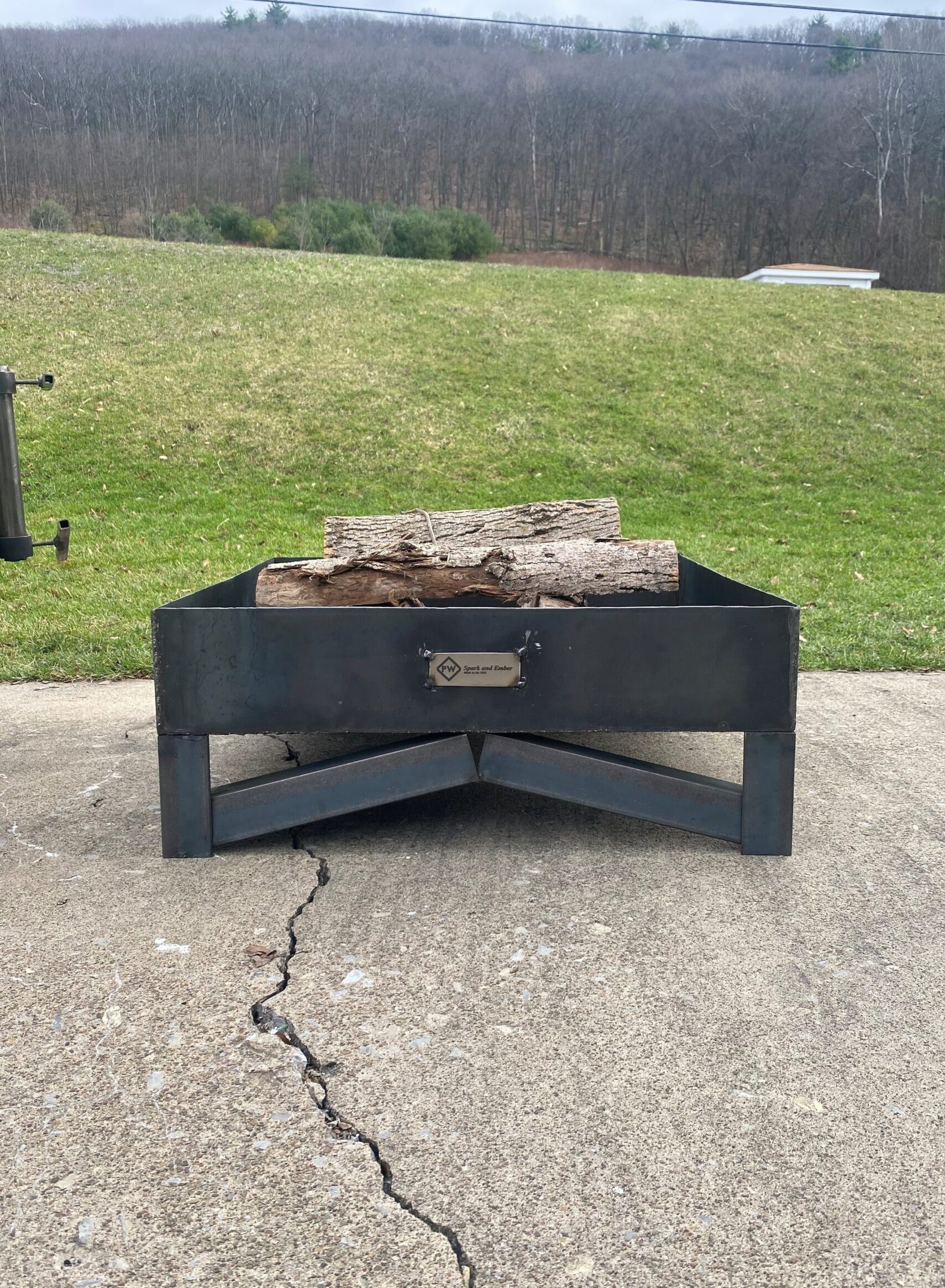 A Square Firepit with logs in it